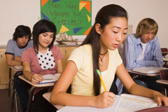 Teenagers doing work at their desks.