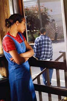 Girl looking at her boyfriend walking out a window.