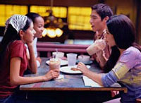 A group of friends sitting at a table in a restaurant.